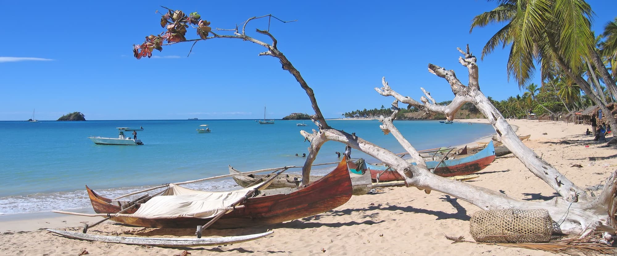 Wide white-sand beach and clear turquoise water at Andilana, Nosy Be, Madagascar