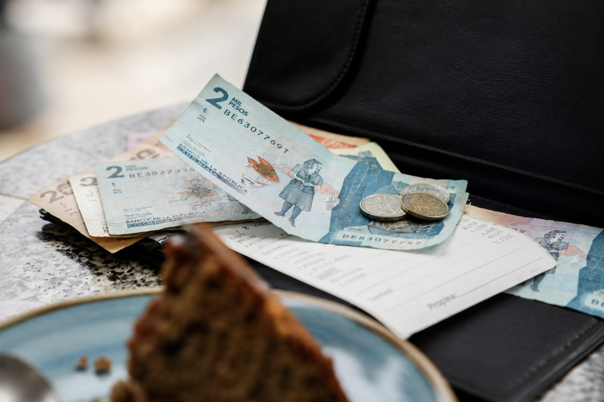 Bills and coins left on a table as a tip after a meal