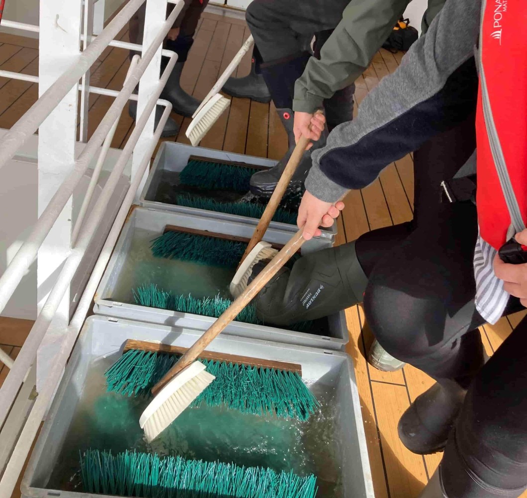 Boot cleaning before the Island landing.