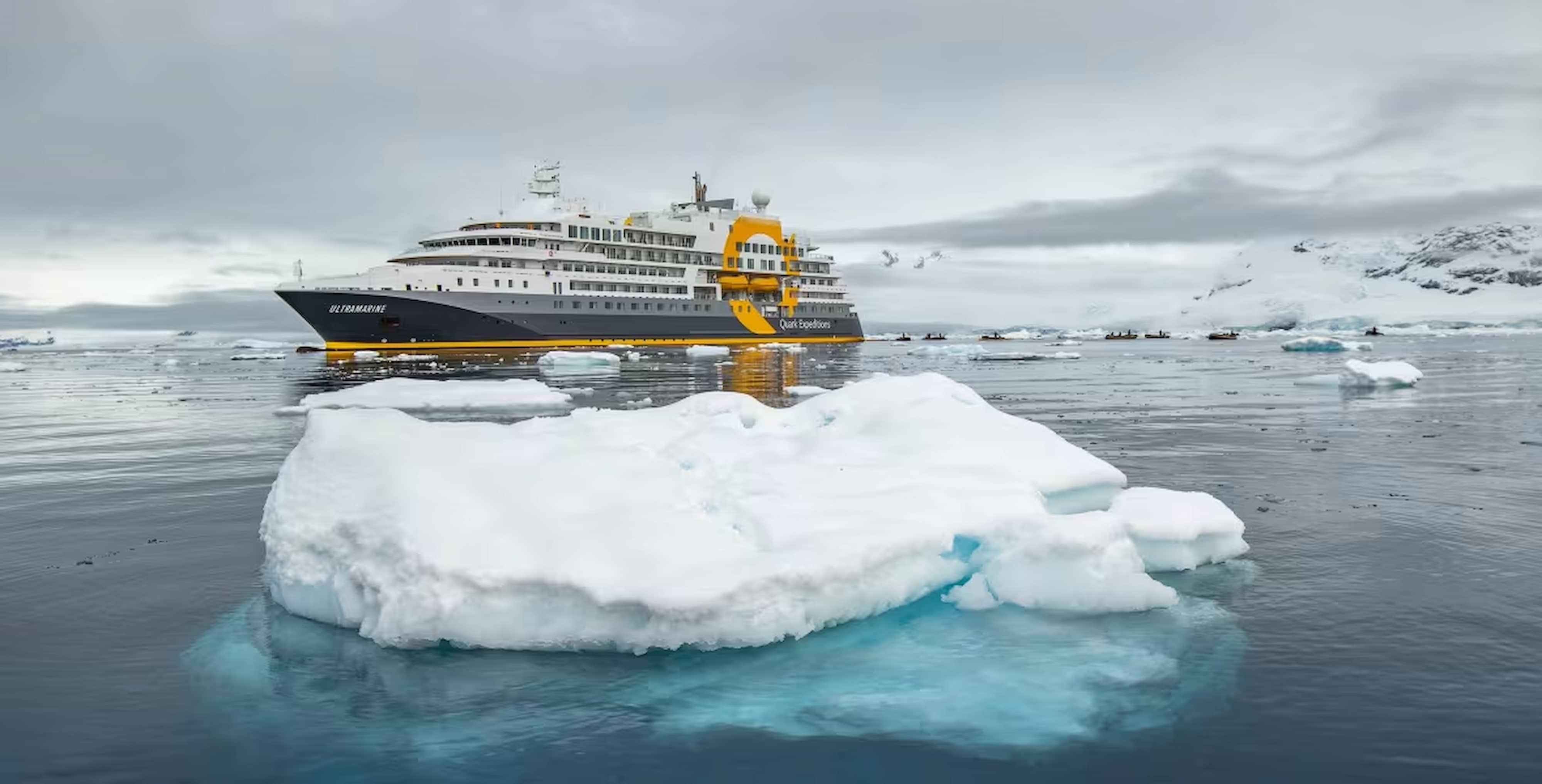 Ultramarine expedition ship from Quark Expeditions sailing through Arctic sea ice during a Svalbard cruise.