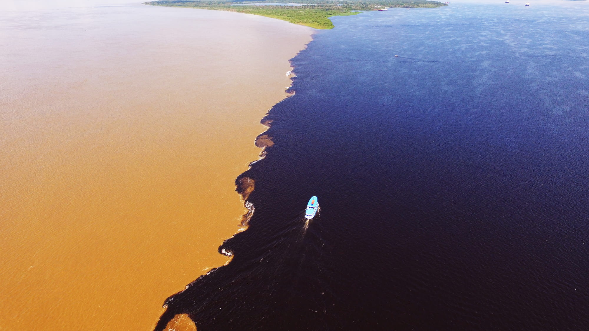 Meeting of the Waters, where the Rio Negro and Rio Solimões flow side by side near Manaus, Brazilian Amazon.