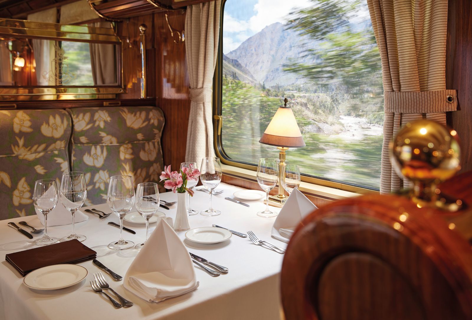 Elegant dinner table set inside the Hiram Bingham luxury train en route to Machu Picchu